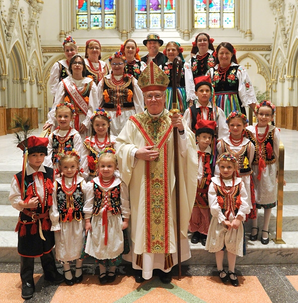 Bishop Malone stands with members of the Polish Heritage Dancers of Western New York after a mass celebrating 1,050 years of Polish commitment to the Catholic faith at St Joseph Cathedral in Downtown Buffalo. (Photo by Dan Cappellazzo)